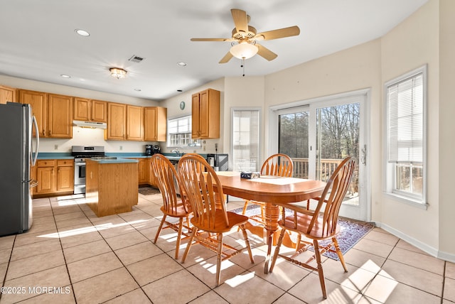 dining room with light tile patterned floors and ceiling fan