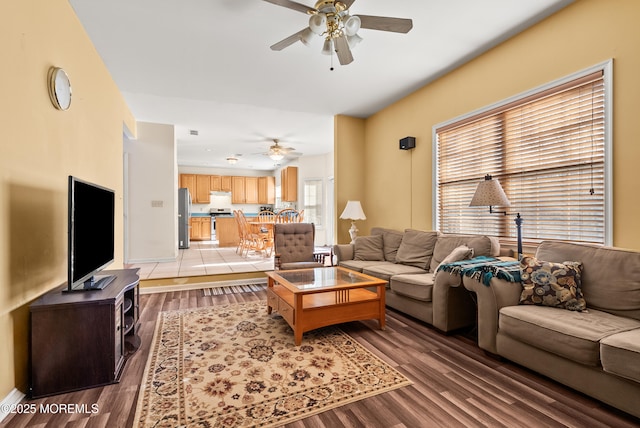 living room featuring wood-type flooring and ceiling fan