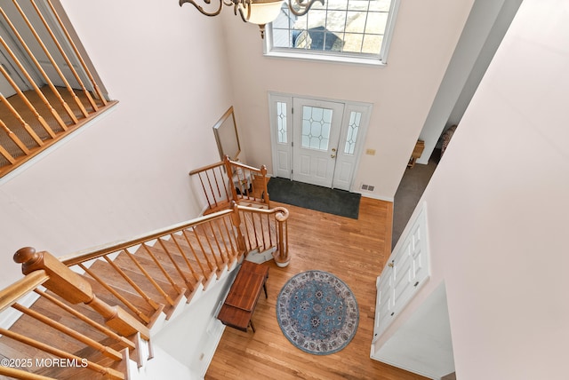 foyer with hardwood / wood-style flooring and a high ceiling