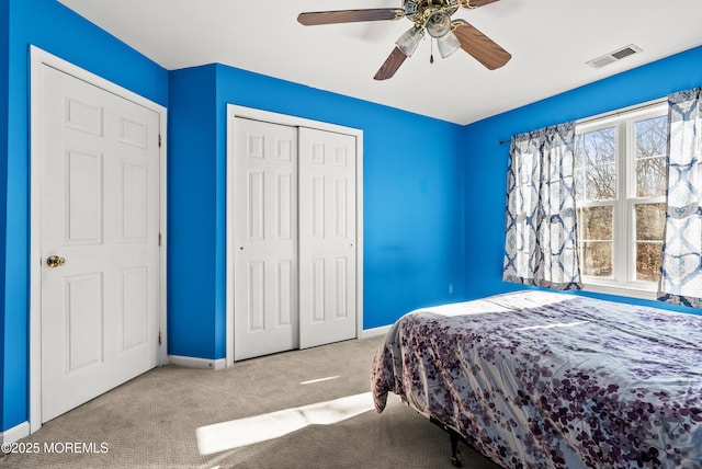 carpeted bedroom featuring multiple windows, a closet, and ceiling fan