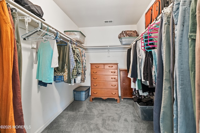 walk in closet featuring light carpet