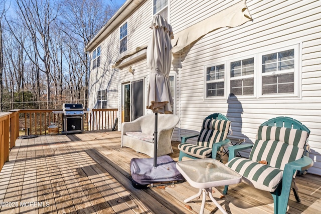 wooden deck featuring a grill