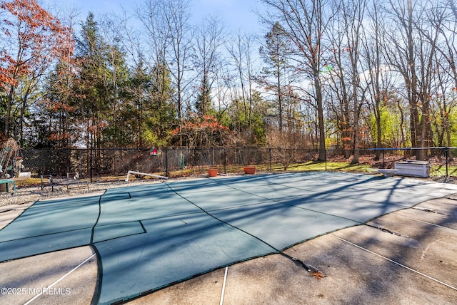 view of swimming pool with tennis court