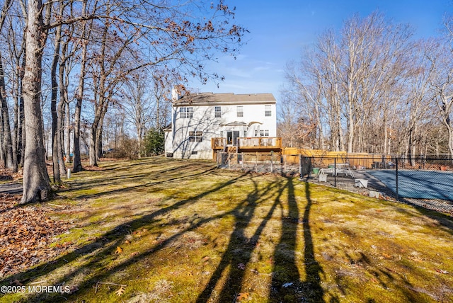 exterior space with a wooden deck and a lawn