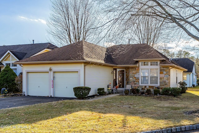 ranch-style home featuring a garage and a front lawn