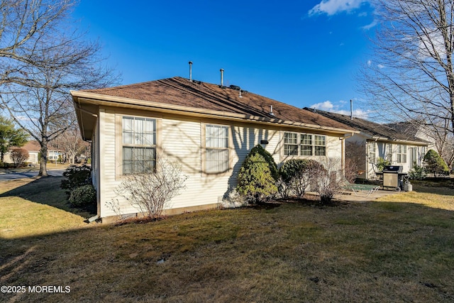 view of side of home featuring a yard