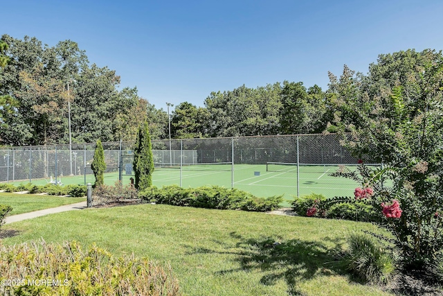 view of sport court with a lawn