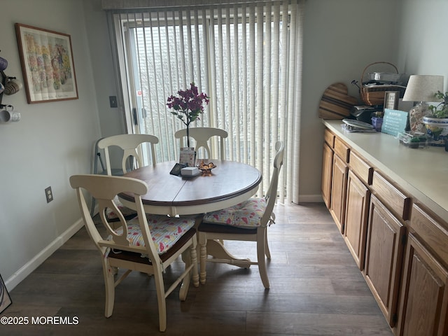 dining space with dark hardwood / wood-style flooring