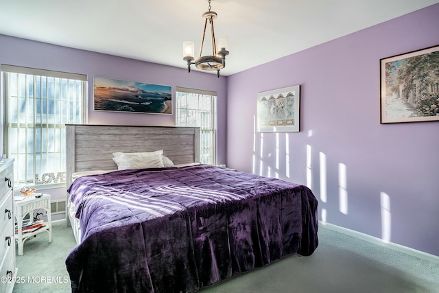 carpeted bedroom with an inviting chandelier