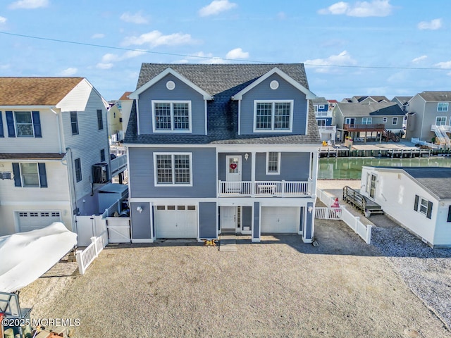 view of front of property featuring a water view and a garage