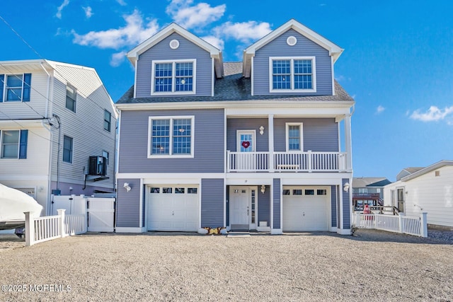 view of front of property with a garage and central AC unit