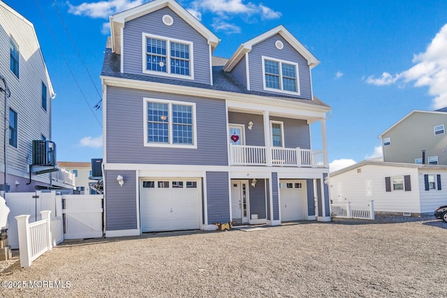 view of front of property with a garage and central AC unit