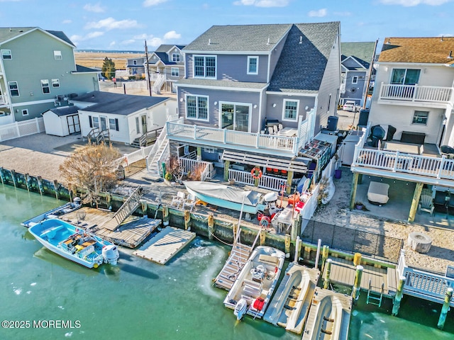 back of property with a water view