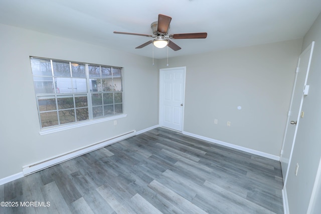 unfurnished room featuring baseboard heating, ceiling fan, and wood-type flooring