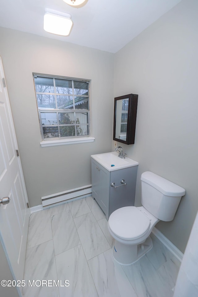 bathroom with vanity, toilet, and baseboard heating