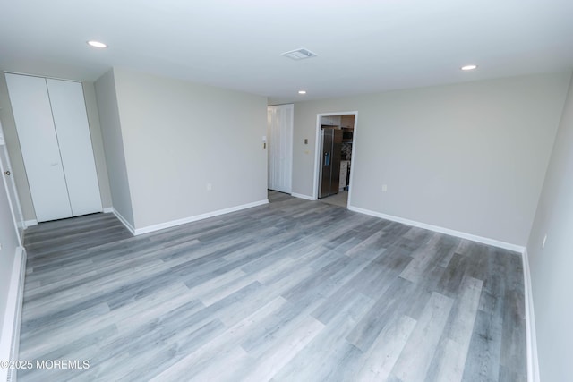 unfurnished room with hardwood / wood-style flooring