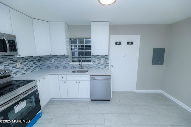 kitchen with stainless steel appliances, electric panel, sink, and white cabinets