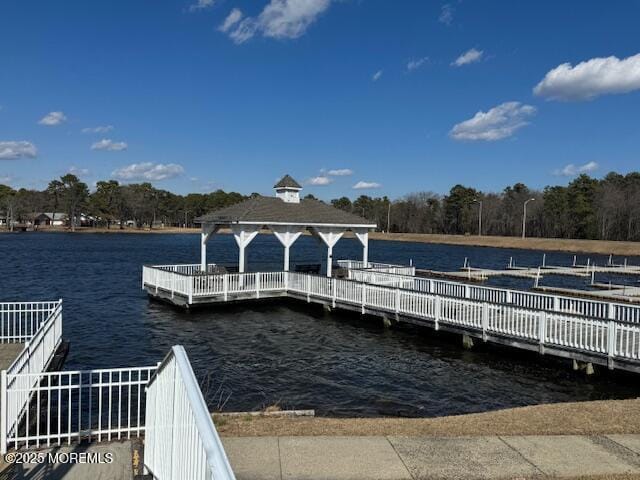 view of dock featuring a water view and a gazebo