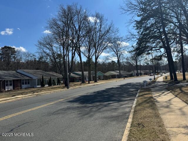 view of road with sidewalks and curbs