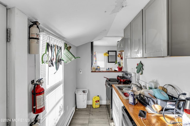 kitchen featuring baseboard heating, appliances with stainless steel finishes, sink, and gray cabinetry