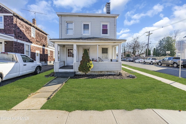 view of front of property with covered porch and a front lawn