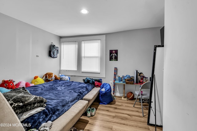 bedroom with hardwood / wood-style flooring