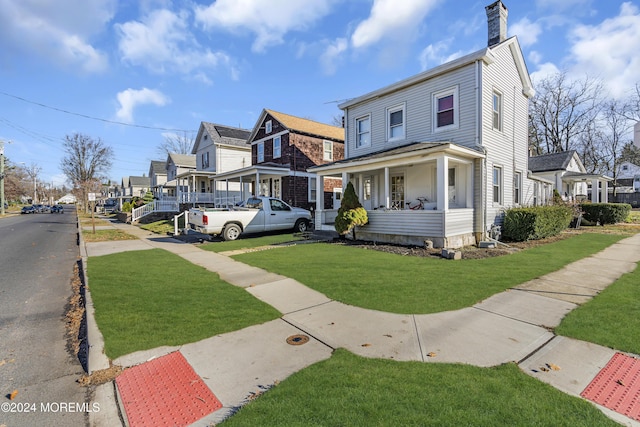 view of front of property with a porch and a front lawn