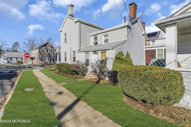 view of property exterior with a yard