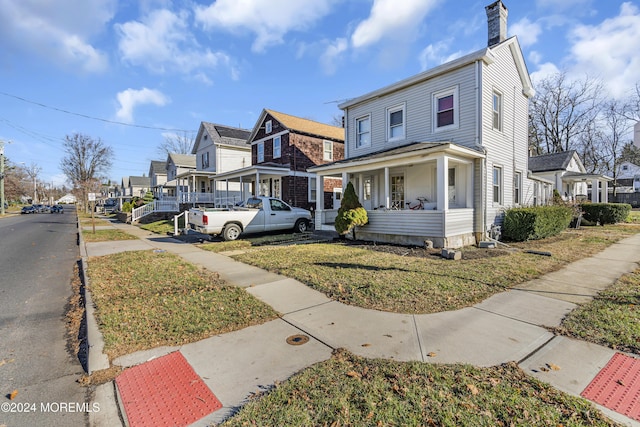 view of front facade with a front yard and a porch