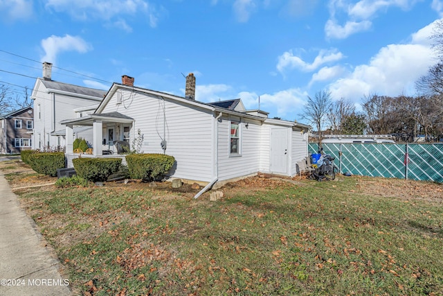 view of side of home featuring a lawn