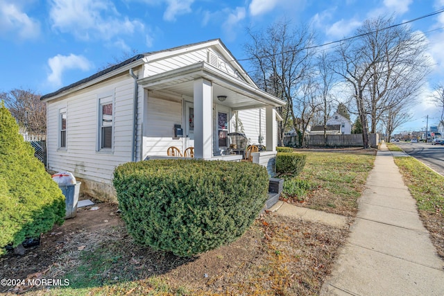 view of side of property with covered porch