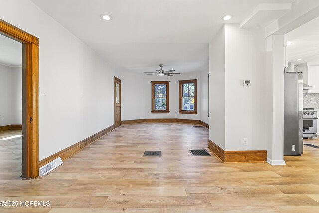 interior space with ceiling fan and light hardwood / wood-style floors