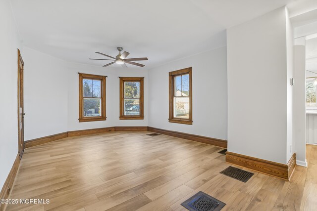 spare room with ceiling fan and light wood-type flooring