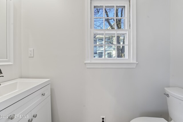 bathroom featuring vanity and toilet