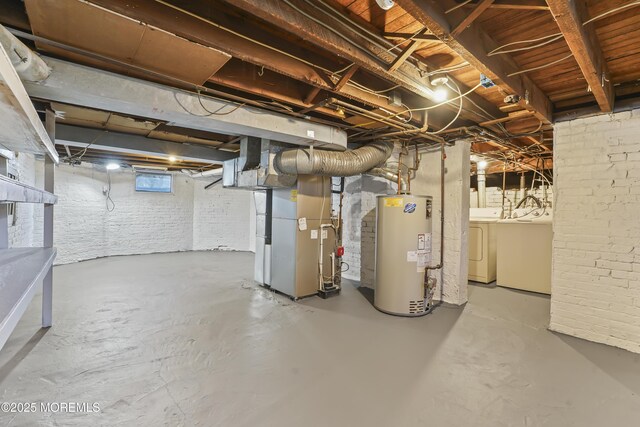 basement with heating unit, gas water heater, and independent washer and dryer