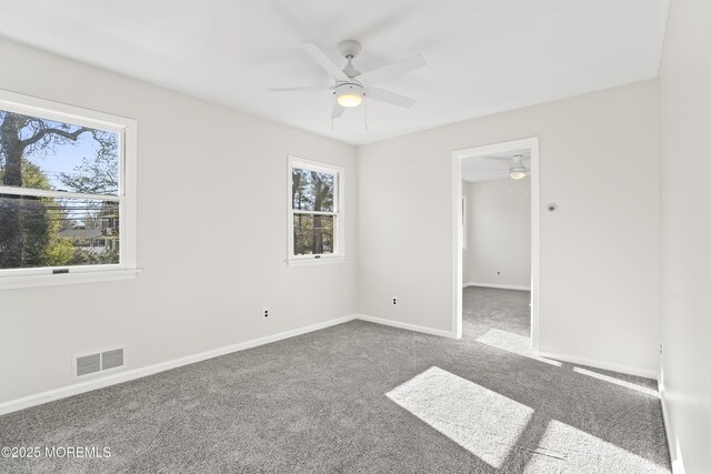 unfurnished room with carpet floors and ceiling fan