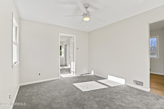 spare room featuring ceiling fan and carpet