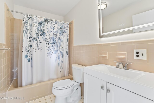 full bathroom featuring vanity, toilet, shower / tub combo, and tile walls