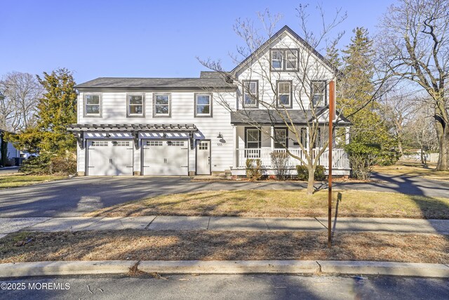 view of front of property featuring a garage and covered porch