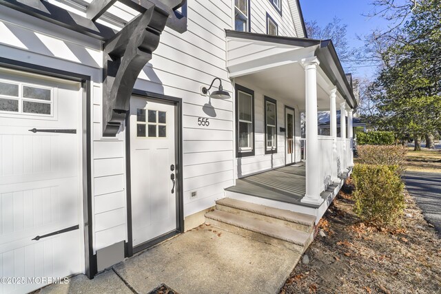 view of exterior entry with a porch