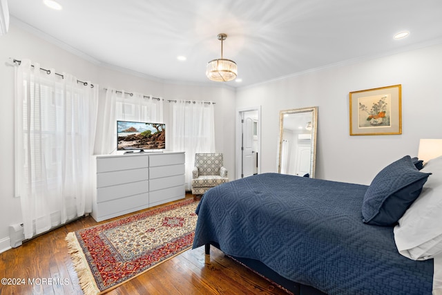 bedroom with ornamental molding and dark hardwood / wood-style flooring