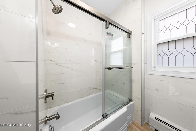 bathroom with enclosed tub / shower combo, a healthy amount of sunlight, tile walls, and baseboard heating