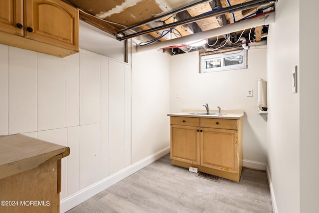 interior space with sink and light hardwood / wood-style flooring