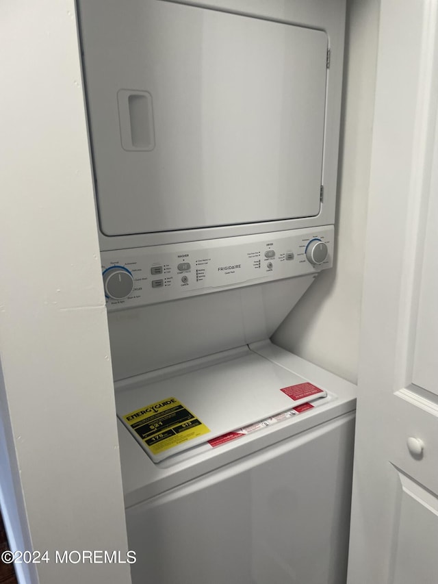 laundry room with stacked washer / drying machine