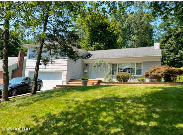 split level home with a garage and a front lawn