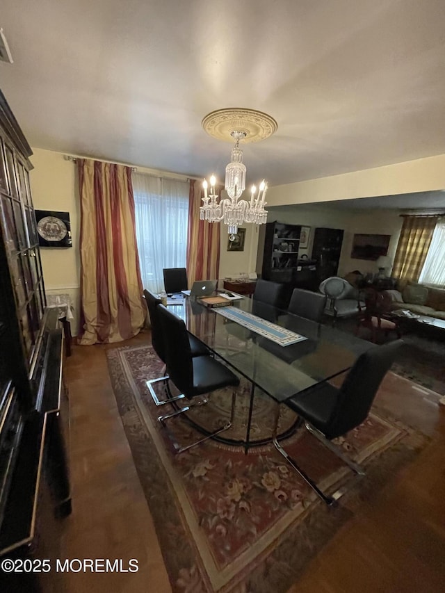 dining area featuring plenty of natural light and a chandelier