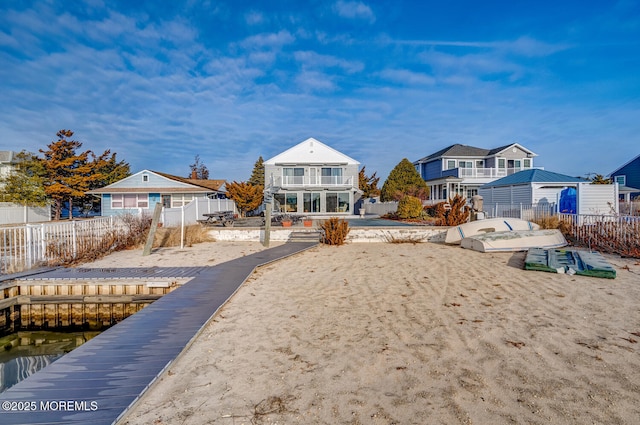 back of house with a balcony and a water view