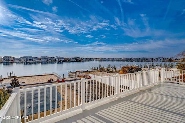 deck with a water view and a dock