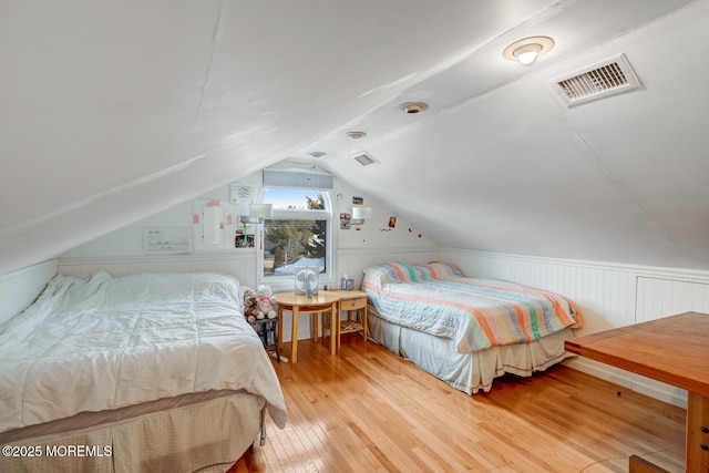 bedroom featuring lofted ceiling and hardwood / wood-style floors