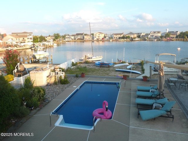 view of swimming pool with a water view and a boat dock